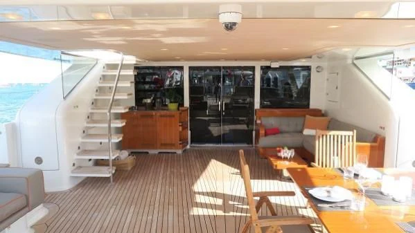 a room with a bed and a table and chairs aboard SERENDIPITY I Yacht for Charter