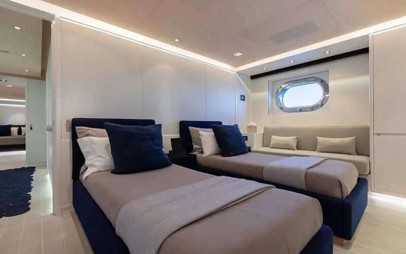 a room with a bed and a couch aboard SERENDIPITY I Yacht for Charter