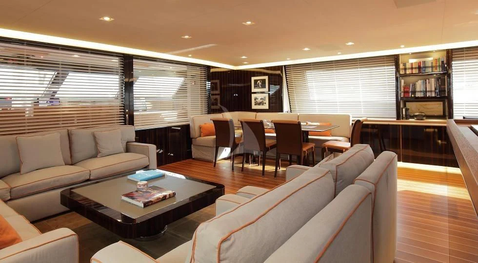 a large room with couches and a coffee table aboard SERENDIPITY I Yacht for Charter