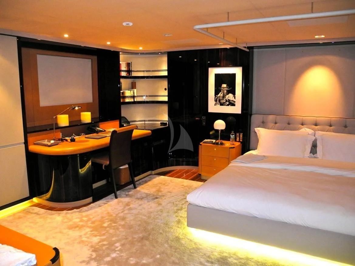 a hotel room with a bed and desk aboard SERENDIPITY I Yacht for Charter
