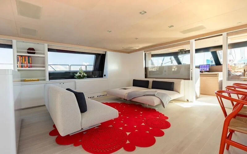 a living room with a red rug aboard SERENDIPITY I Yacht for Charter