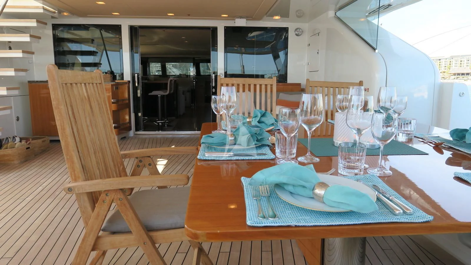 a table with a plate and chairs aboard SERENDIPITY I Yacht for Charter