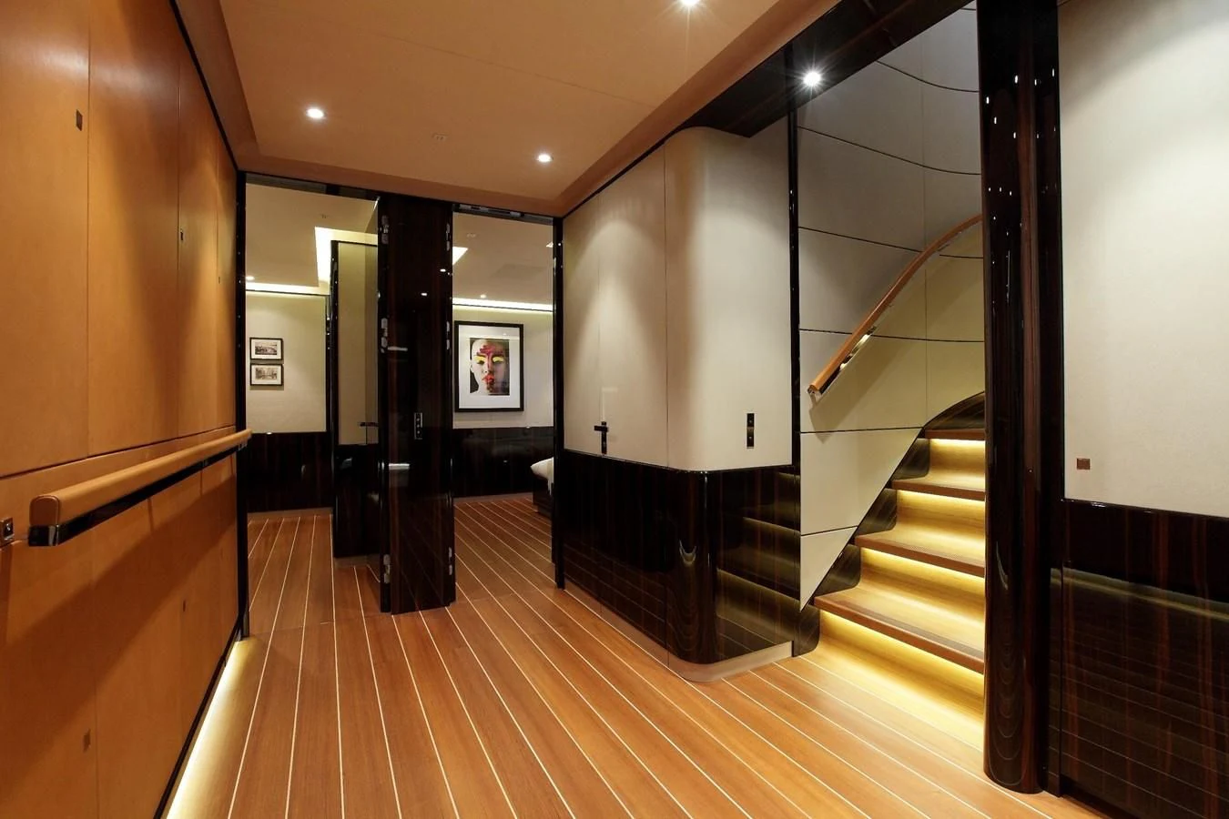 a hallway with wood floors and a staircase aboard SERENDIPITY I Yacht for Charter