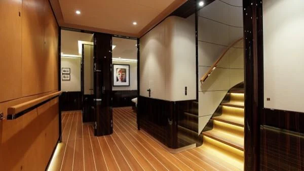 a hallway with wood floors and a staircase aboard SERENDIPITY I Yacht for Charter