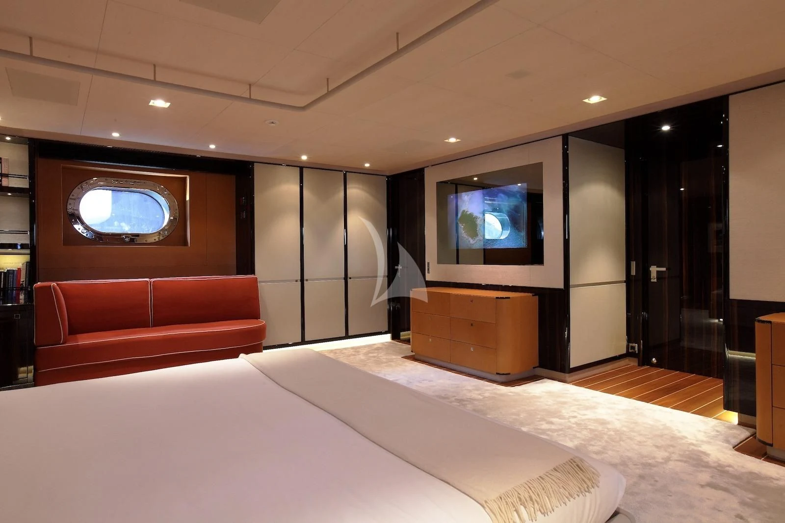 a hotel room with a bed and a tv aboard SERENDIPITY I Yacht for Charter