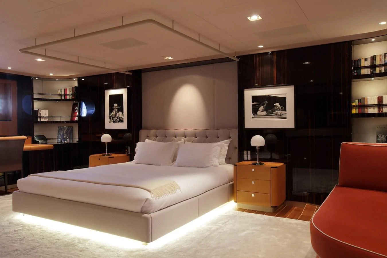 a large bedroom with a bed and a chair aboard SERENDIPITY I Yacht for Charter
