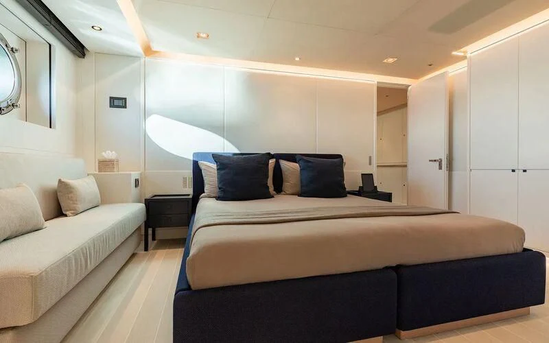 a room with a bed and a desk aboard SERENDIPITY I Yacht for Charter