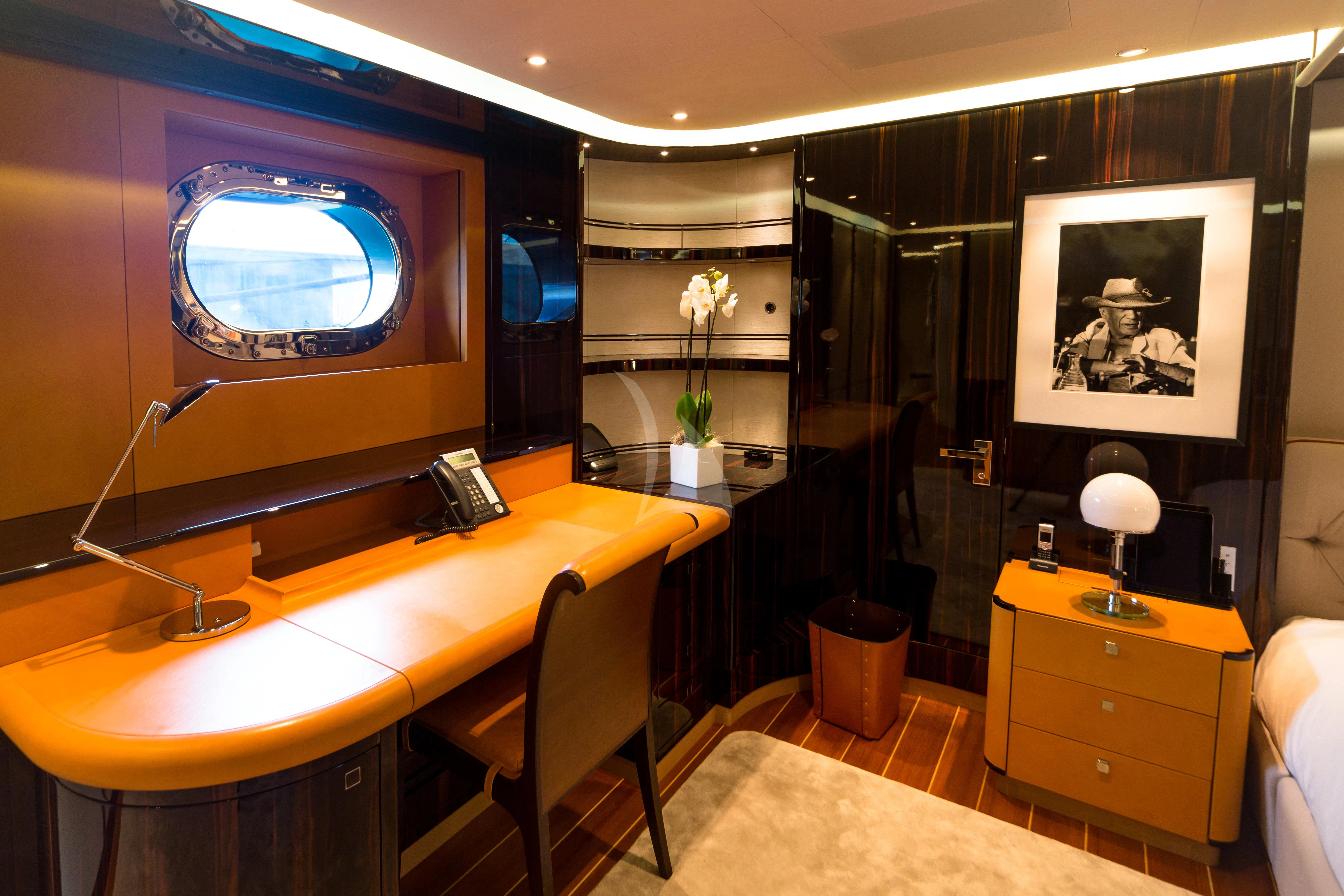 a room with a desk and a tv aboard SERENDIPITY I Yacht for Charter