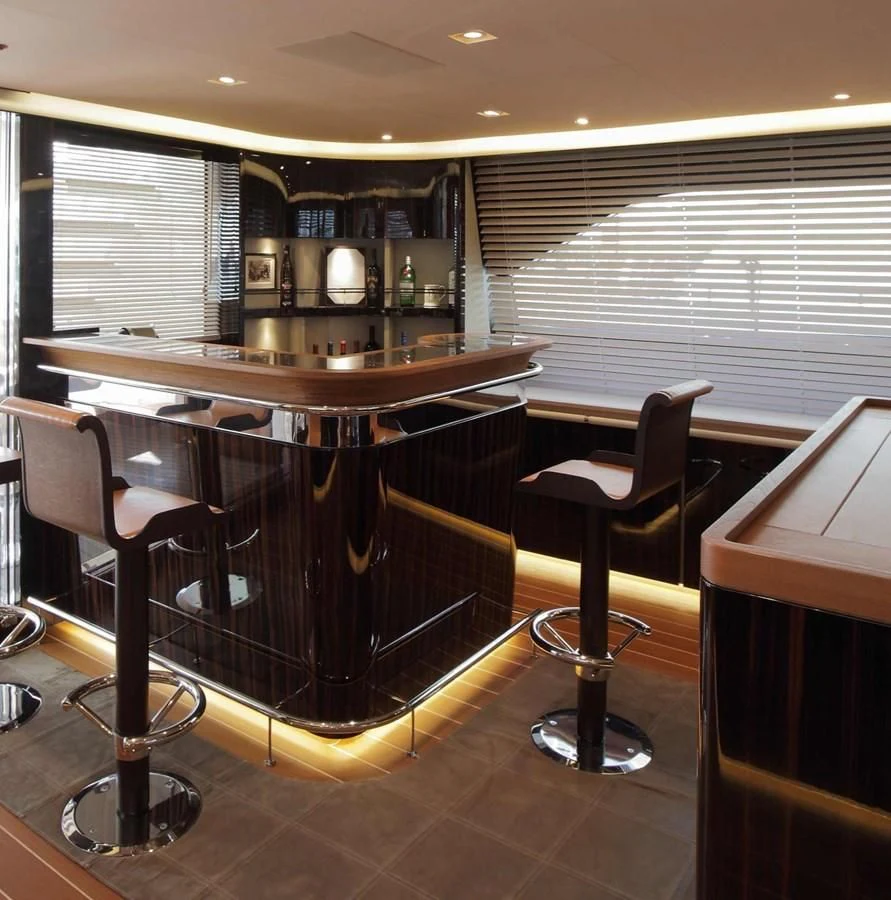a bar with a bar and chairs aboard SERENDIPITY I Yacht for Charter