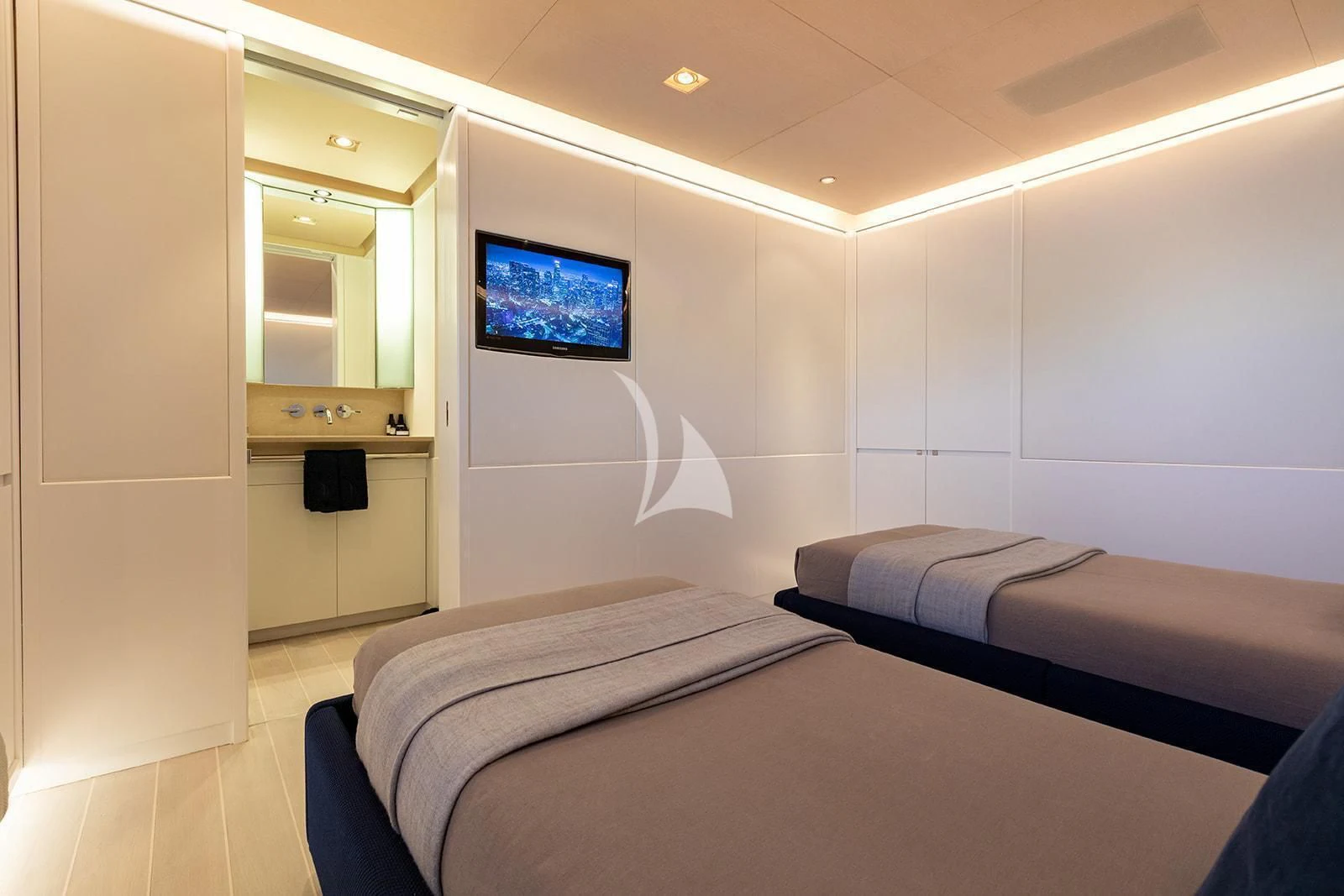 a room with a bed and a tv on the wall aboard SERENDIPITY I Yacht for Charter