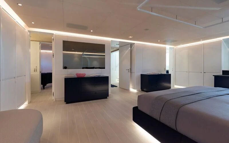 a bedroom with a bed and a tv aboard SERENDIPITY I Yacht for Charter