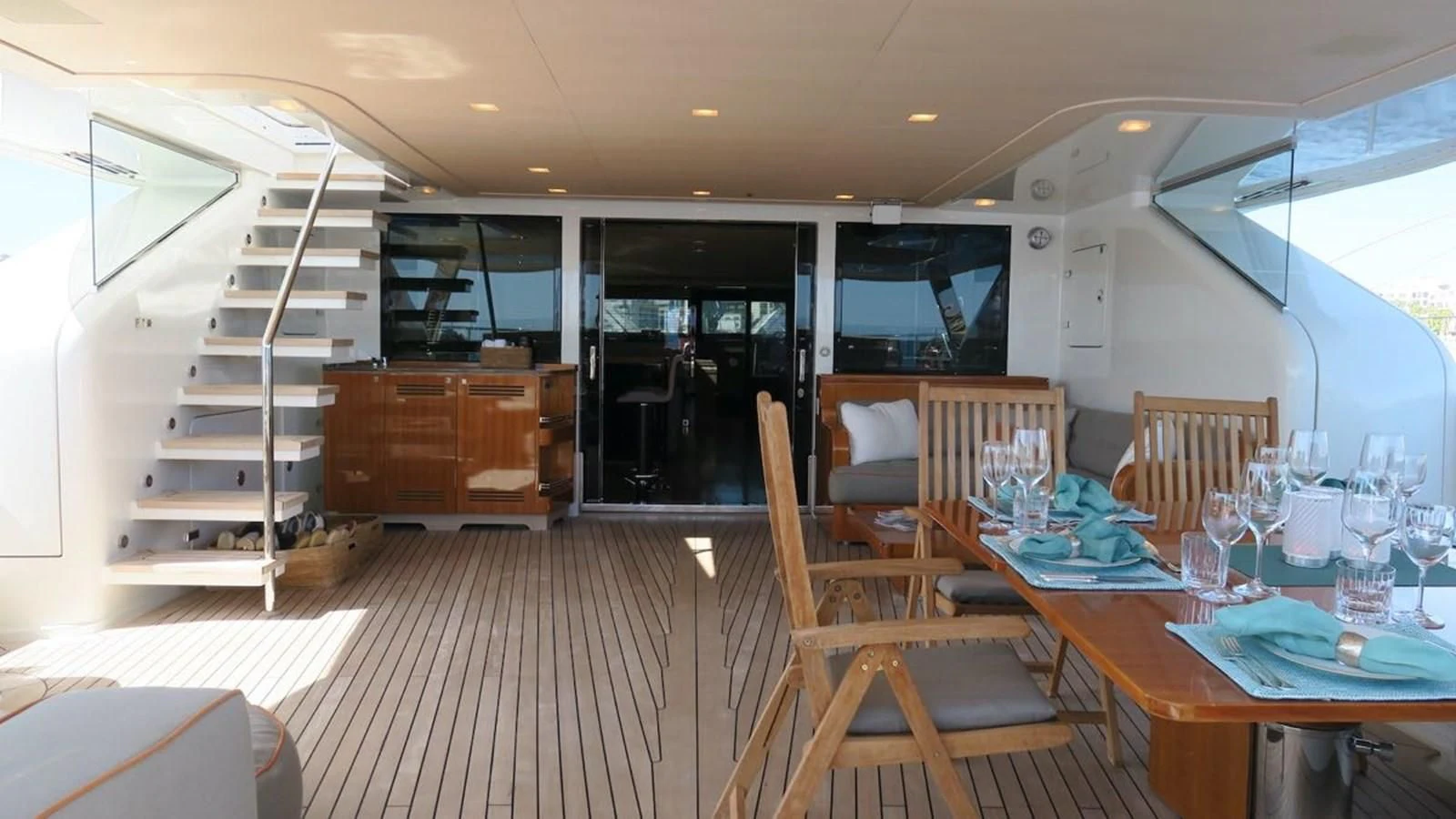 a room with a table chairs and a staircase aboard SERENDIPITY I Yacht for Charter