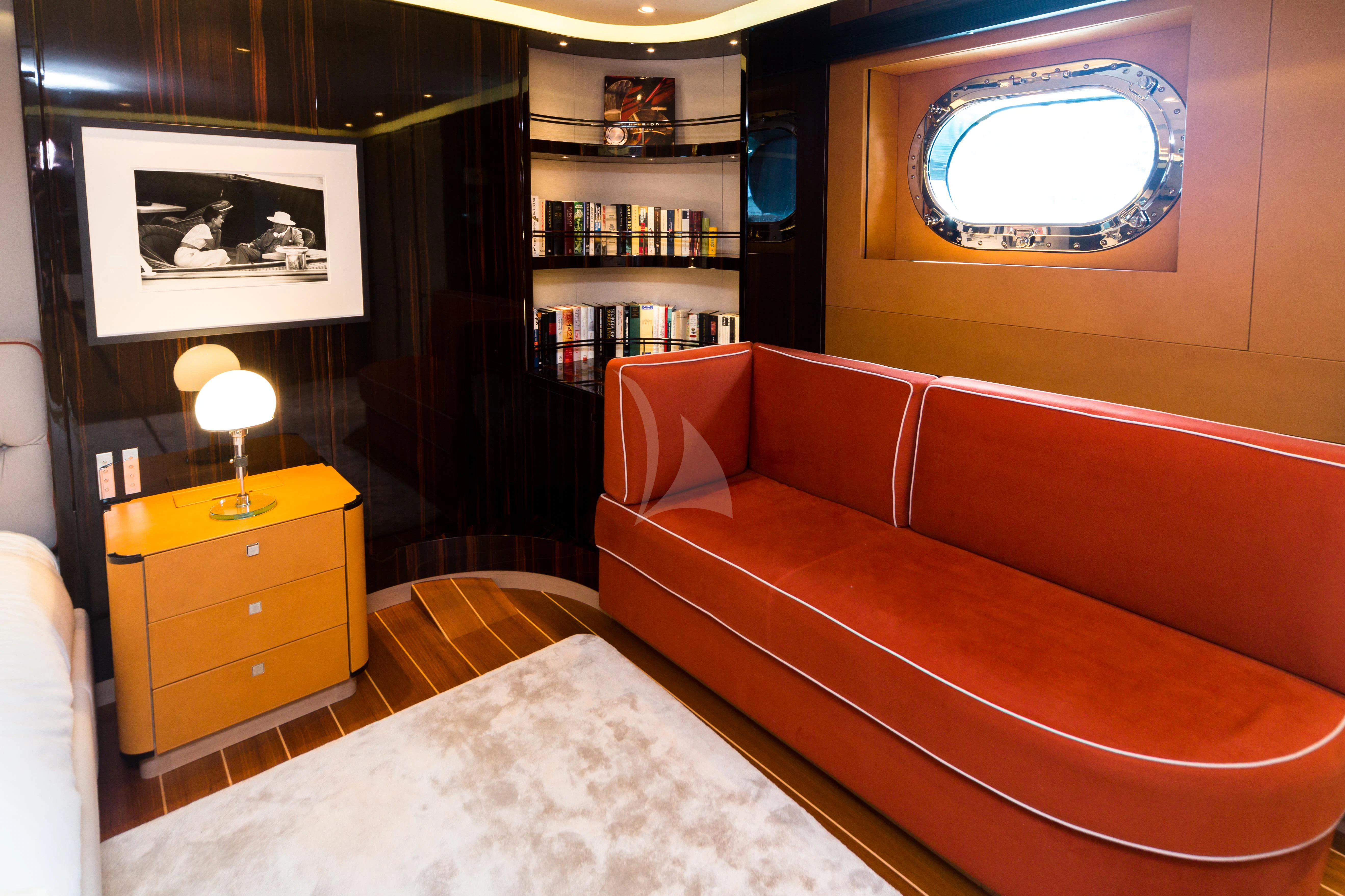 a room with a bed and a bookcase aboard SERENDIPITY I Yacht for Charter