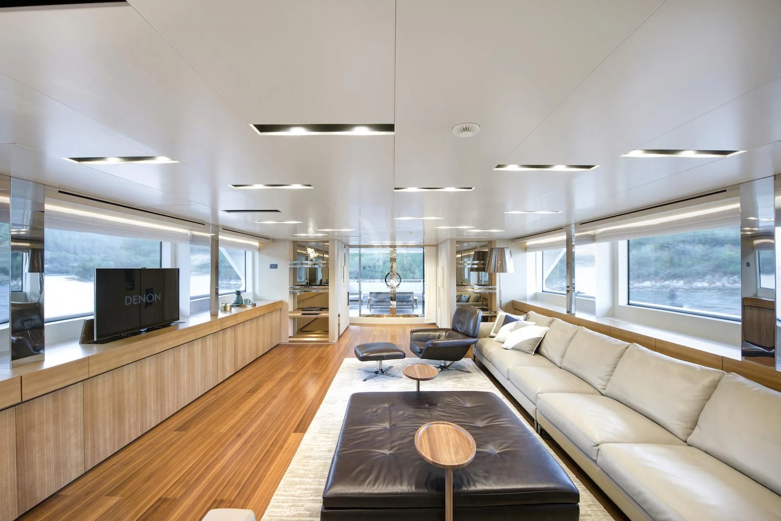 a living room with a wood floor aboard THERAPY Yacht for Sale