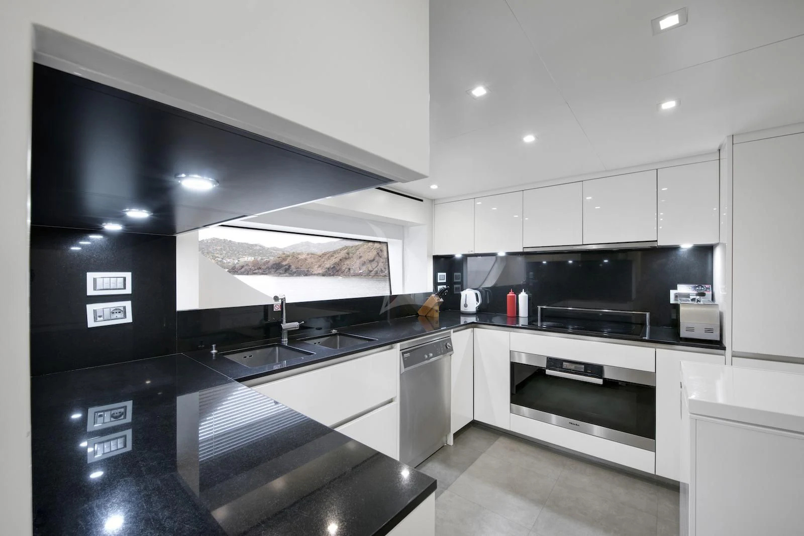 a kitchen with white cabinets aboard THERAPY Yacht for Sale