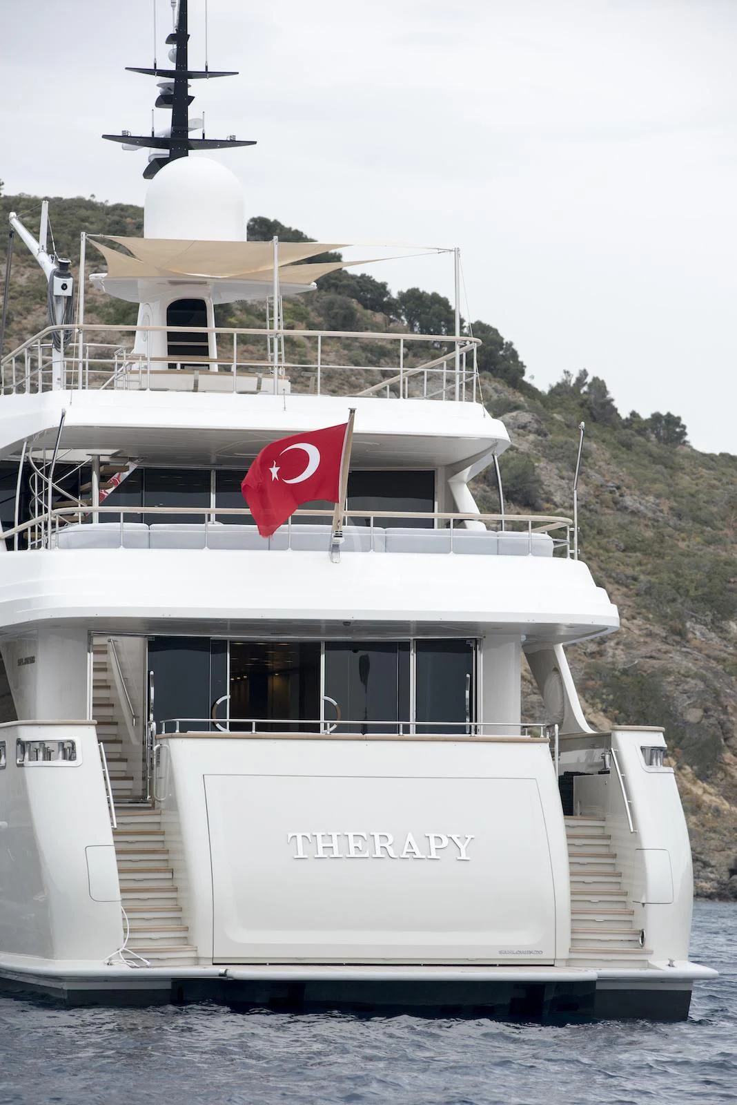 a boat with a flag on the front aboard THERAPY Yacht for Sale