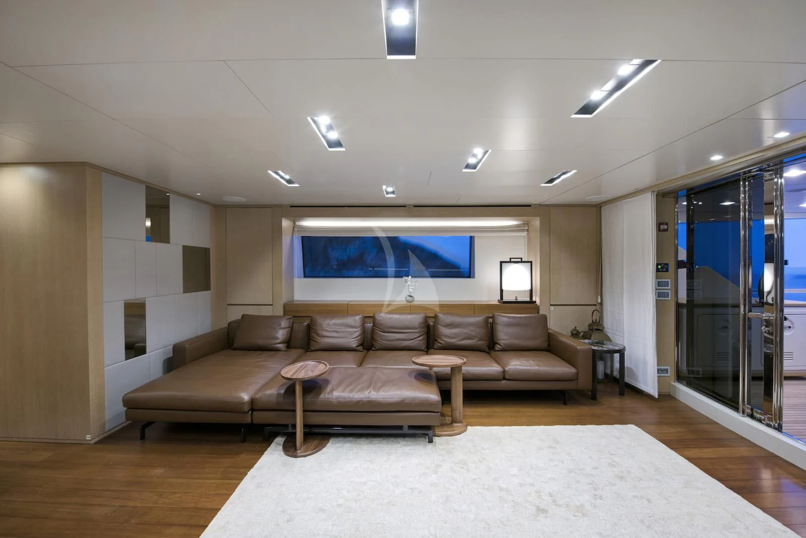 a living room with a large sofa aboard THERAPY Yacht for Sale