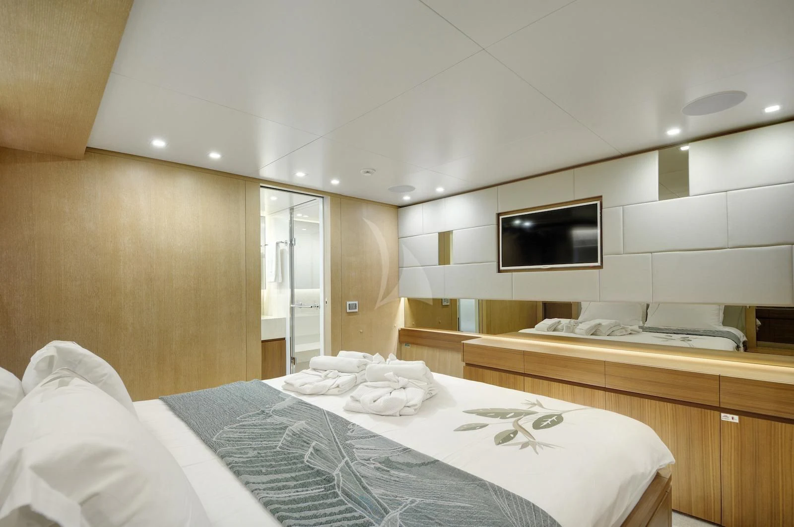 a room with a bed and a television aboard THERAPY Yacht for Sale