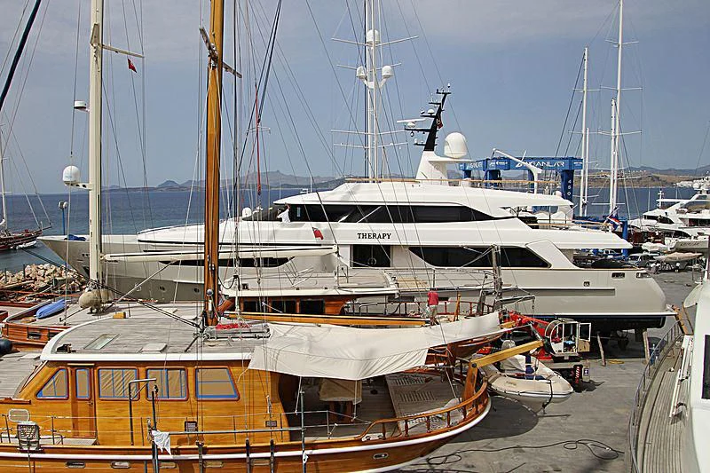 a boat docked at a pier aboard THERAPY Yacht for Sale