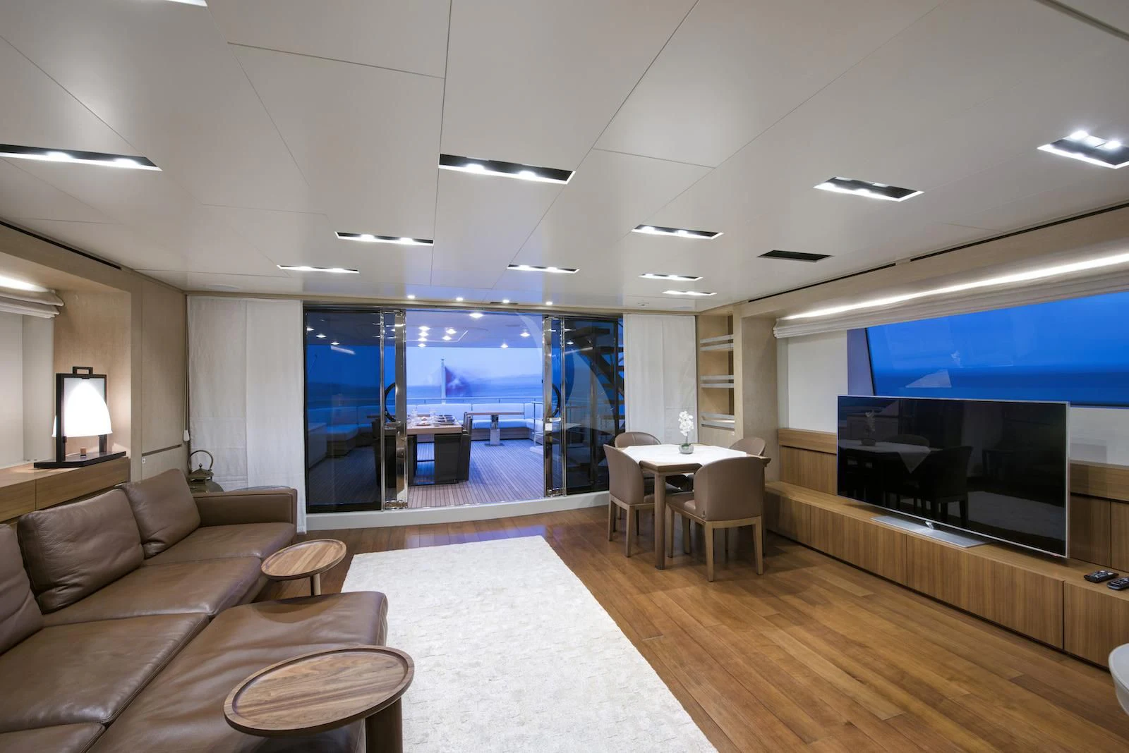 a living room with a large screen aboard THERAPY Yacht for Sale
