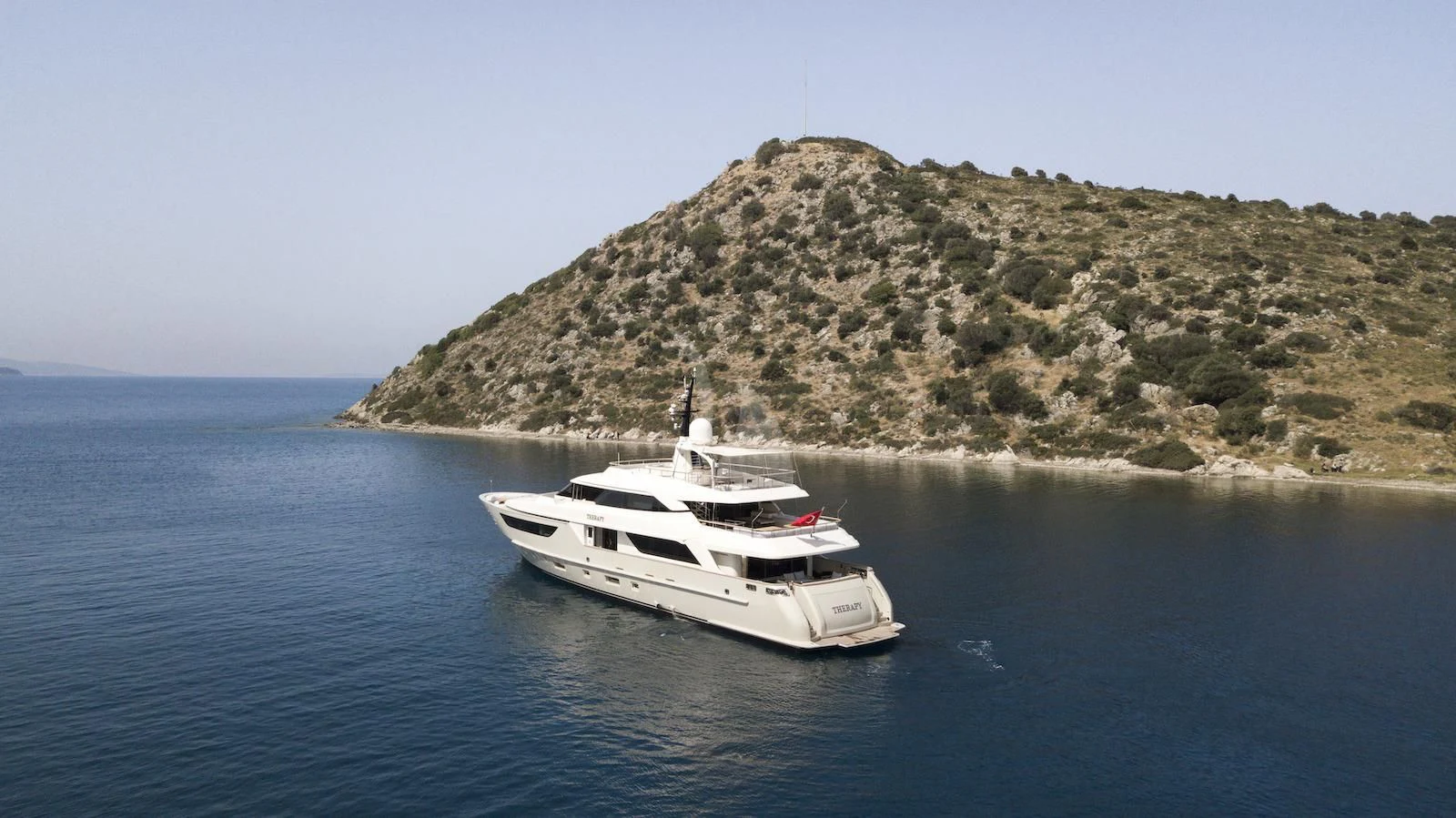 a white yacht in the water aboard THERAPY Yacht for Sale
