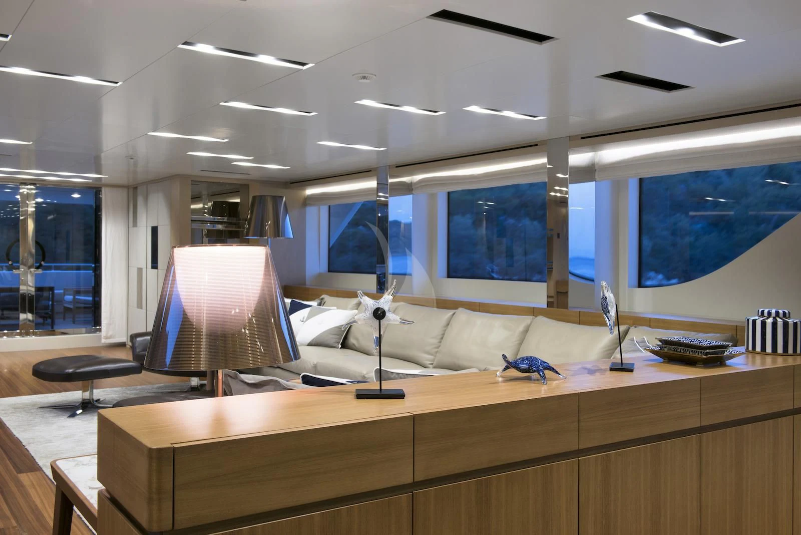 a room with a desk and a lamp on the table aboard THERAPY Yacht for Sale