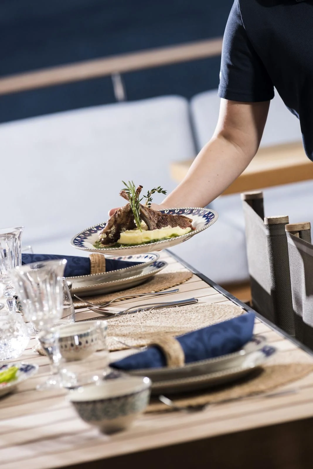 a table with plates of food and glasses on it aboard THERAPY Yacht for Sale