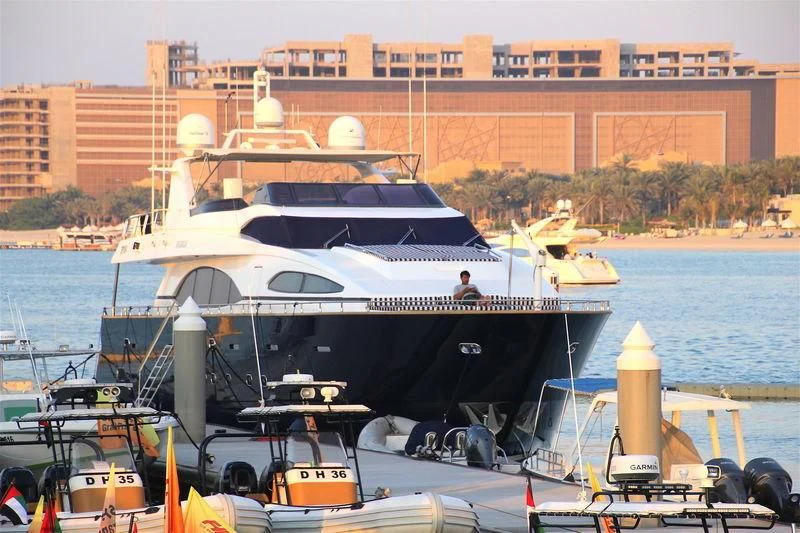 a large white boat on a body of water aboard SPECTRE Yacht for Sale