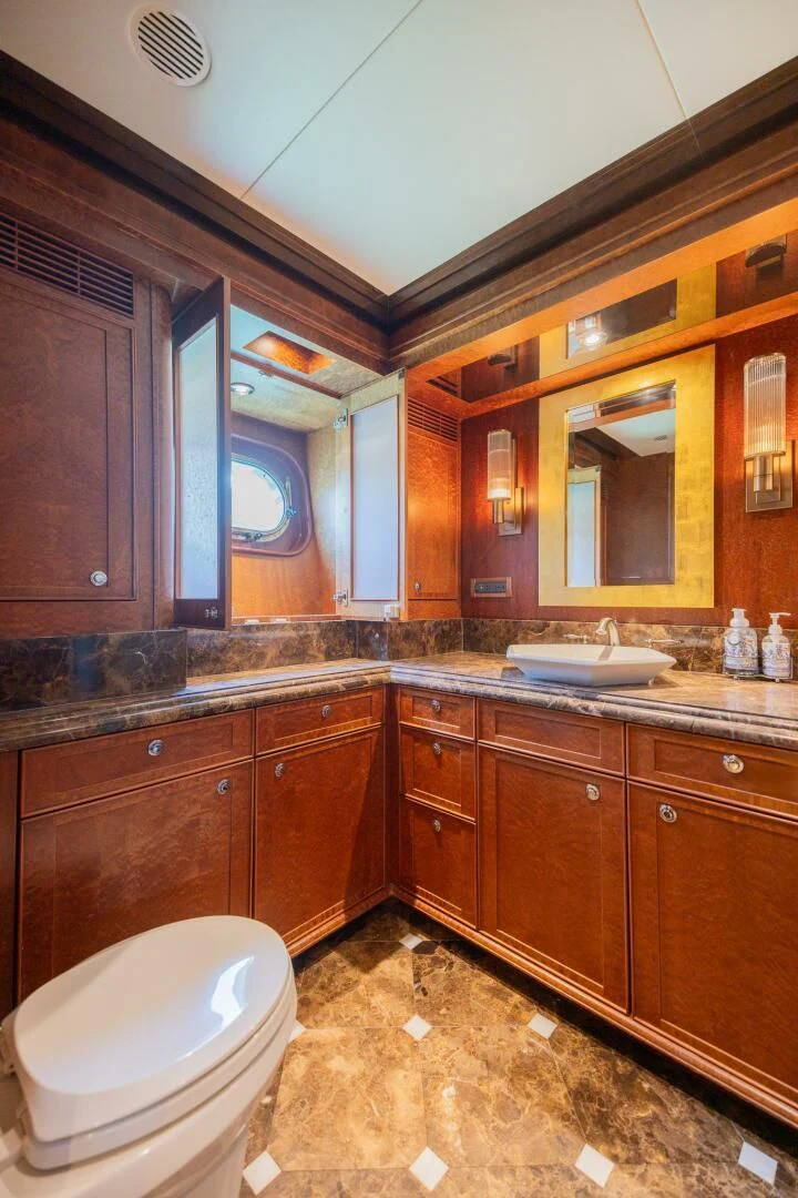 a bathroom with a toilet and a sink aboard PREDATOR I Yacht for Sale