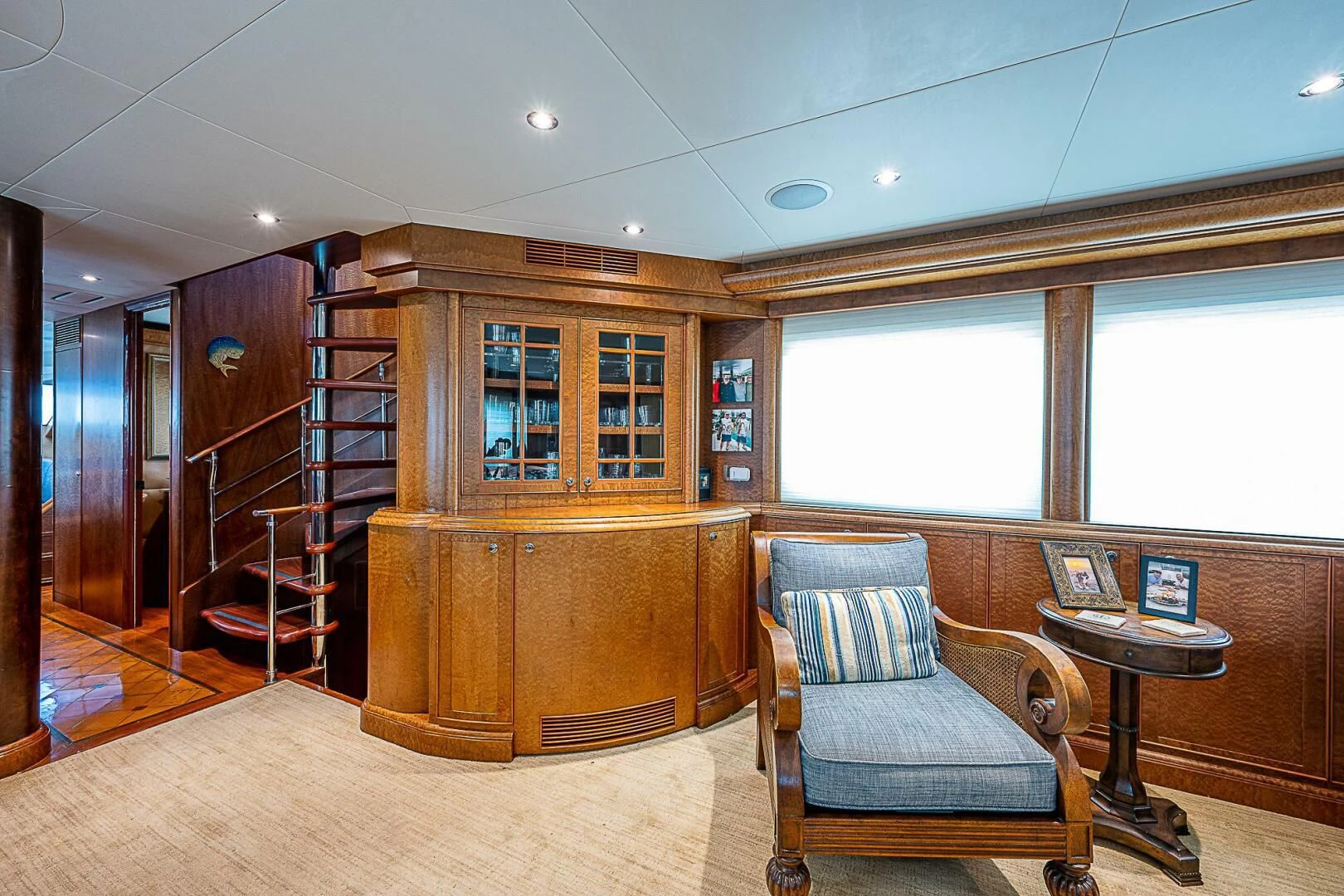 a room with a chair and a table and a bookcase aboard PREDATOR I Yacht for Sale