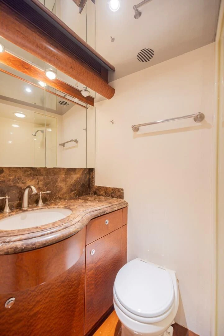 a bathroom with a toilet and a sink aboard PREDATOR I Yacht for Sale