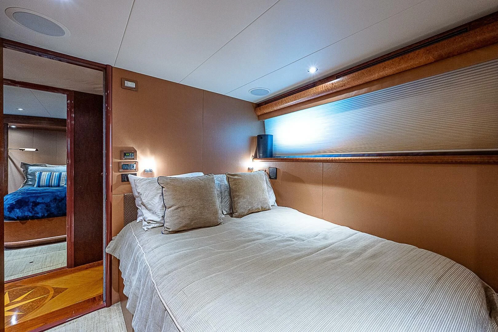 a room with a bed and a mirror aboard PREDATOR I Yacht for Sale
