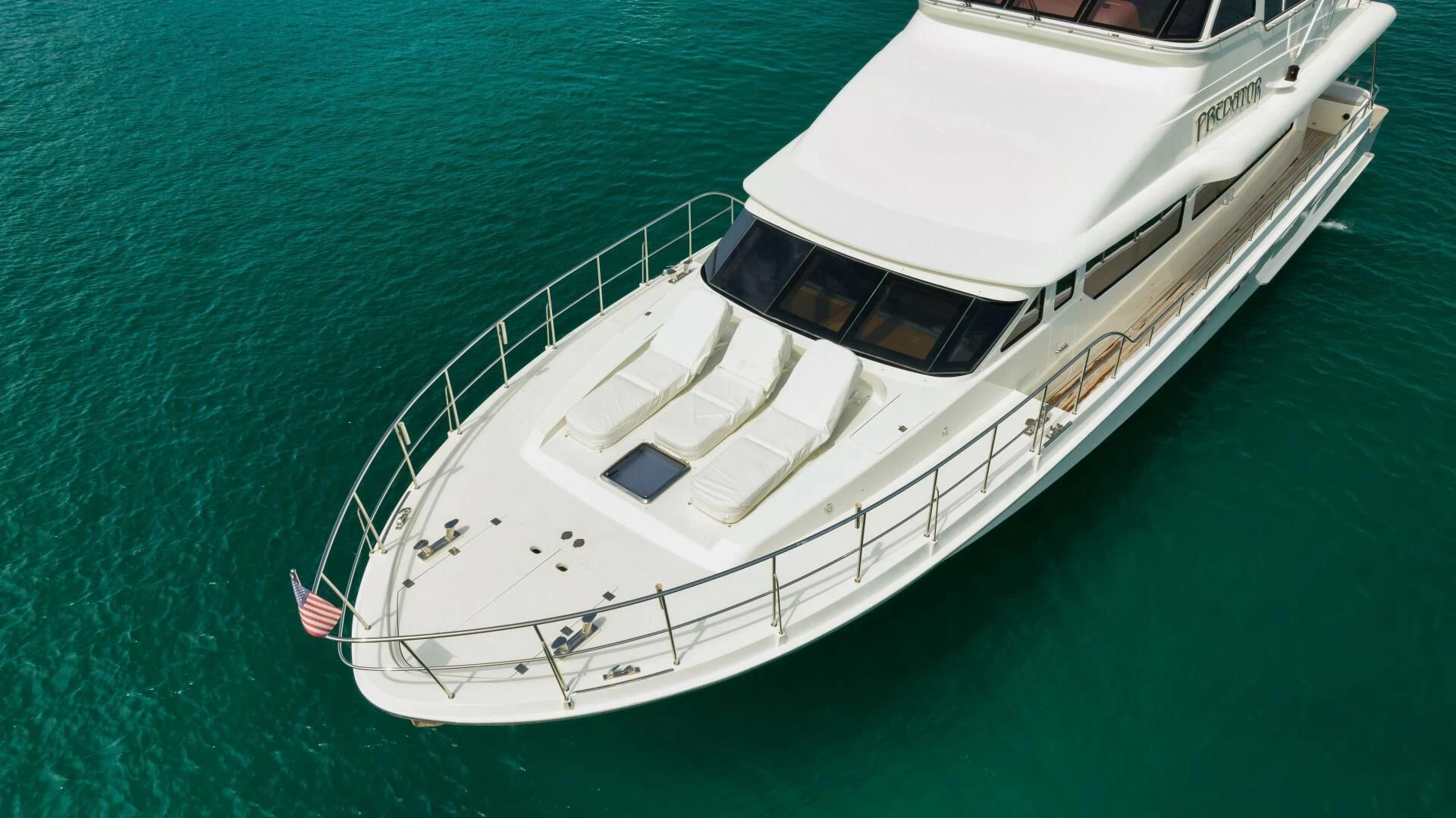 a white boat on the water aboard PREDATOR I Yacht for Sale