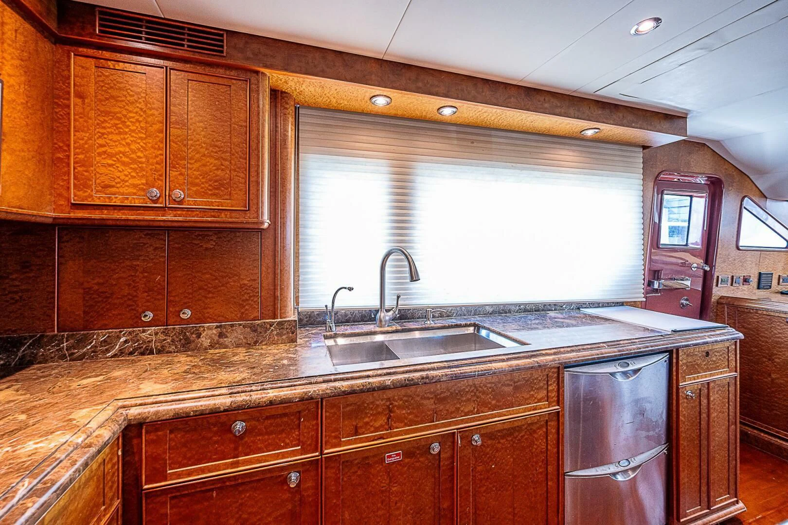 a kitchen with wooden cabinets aboard PREDATOR I Yacht for Sale