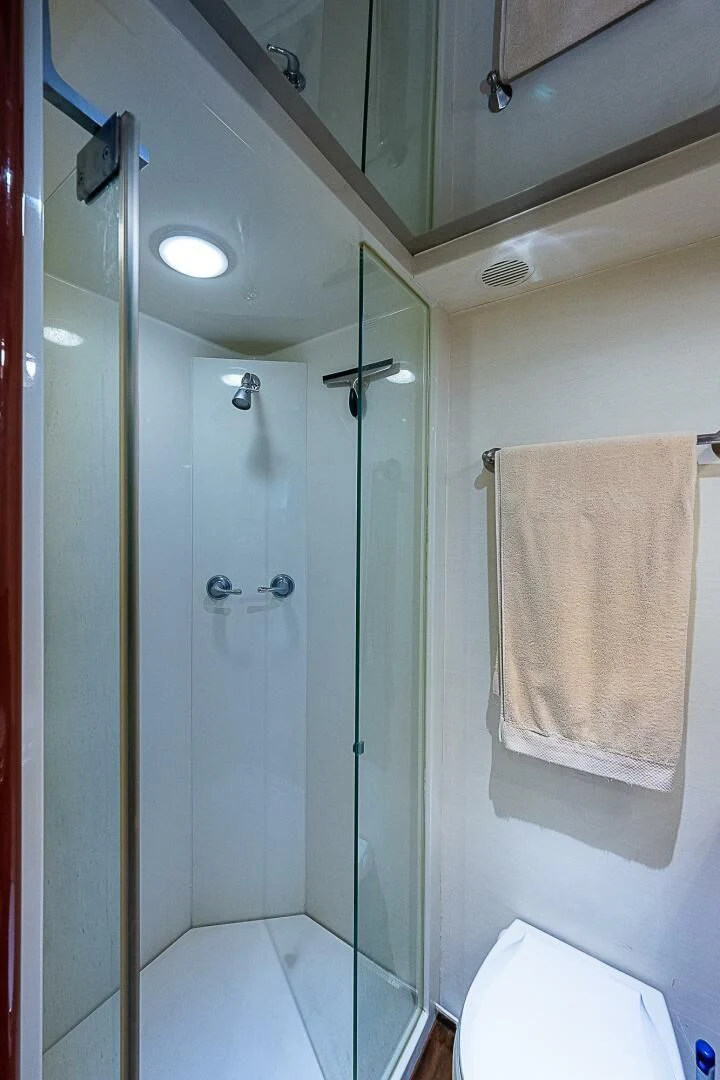 a bathroom with a shower and a towel on the wall aboard PREDATOR I Yacht for Sale