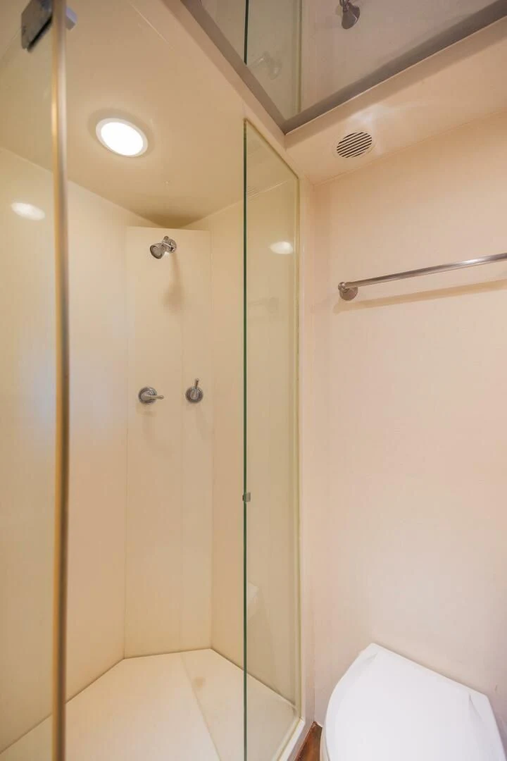 a bathroom with a glass shower aboard PREDATOR I Yacht for Sale