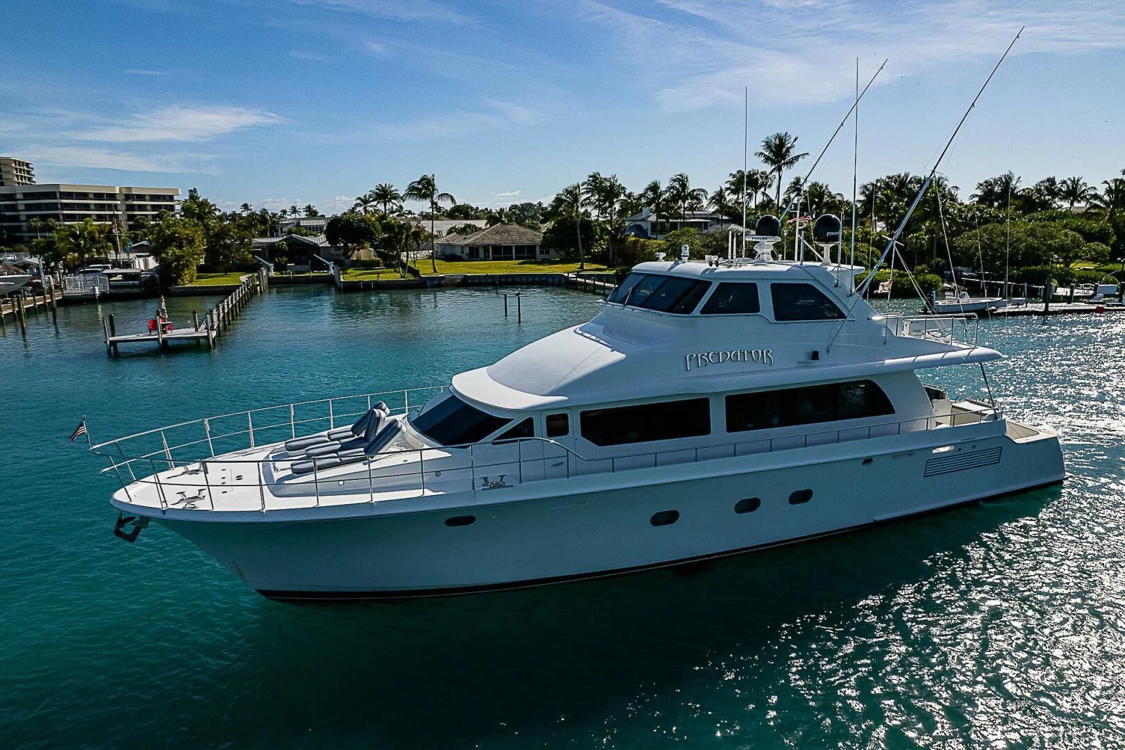 a white yacht in a harbor aboard PREDATOR I Yacht for Sale