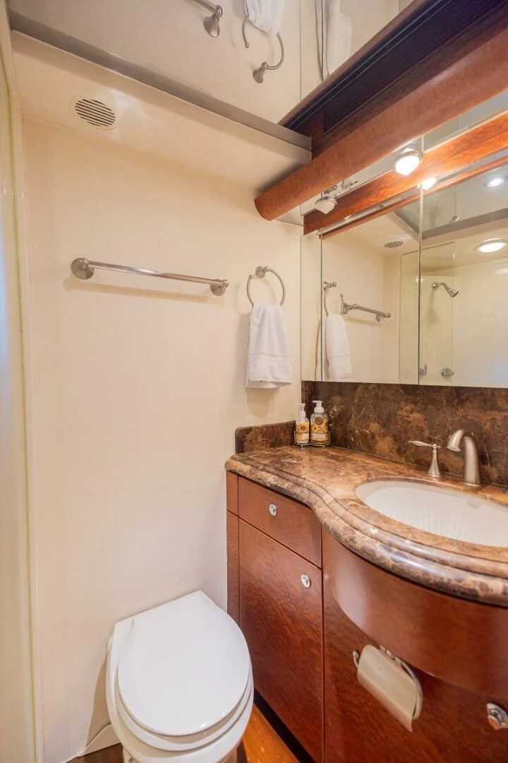 a bathroom with a toilet and a sink aboard PREDATOR I Yacht for Sale