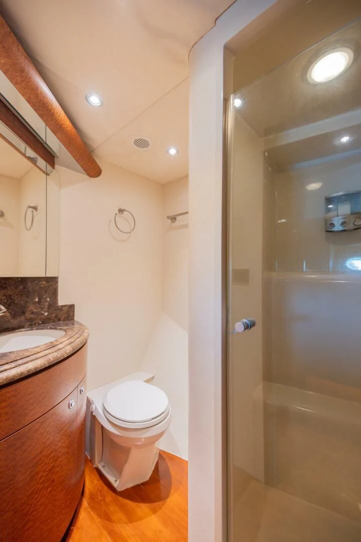 a bathroom with a glass shower door aboard PREDATOR I Yacht for Sale