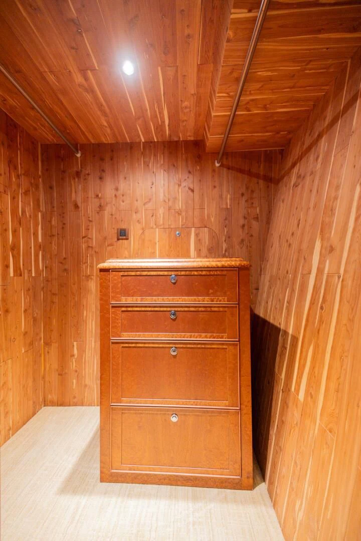 a wooden cabinet in a wooden room aboard PREDATOR I Yacht for Sale