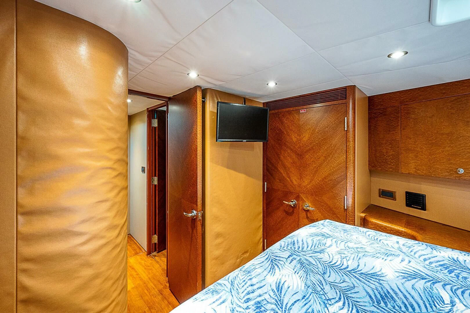 a bedroom with a bed and a television aboard PREDATOR I Yacht for Sale