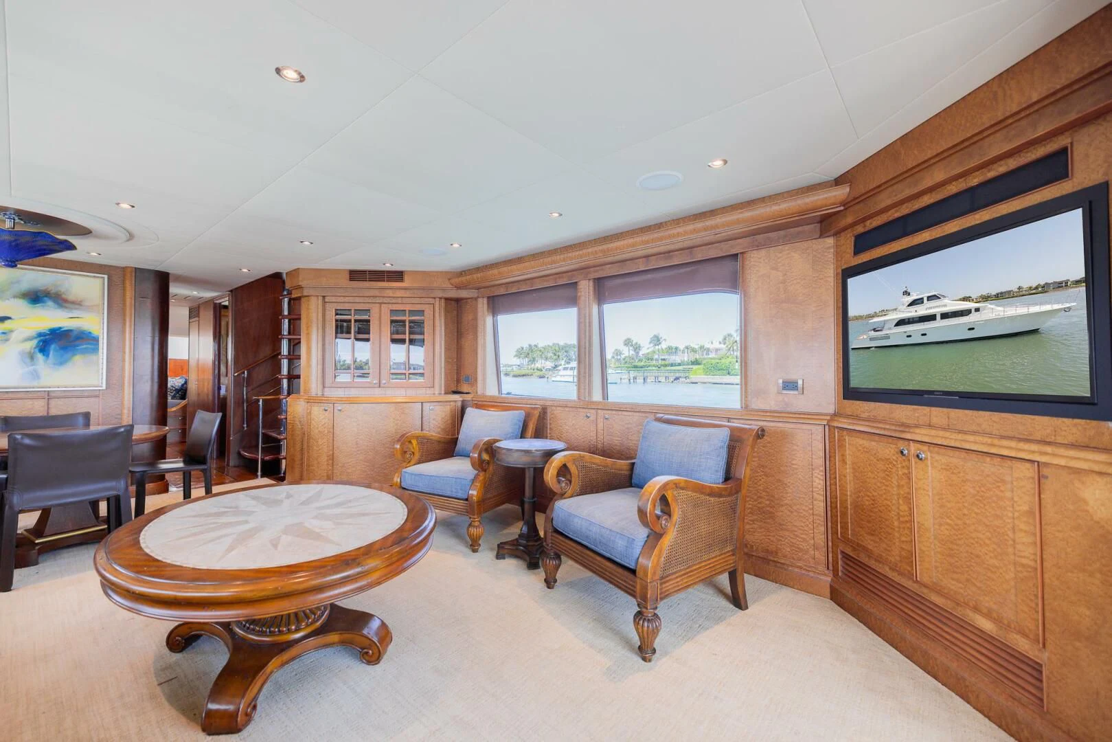 a living room with a table and chairs aboard PREDATOR I Yacht for Sale