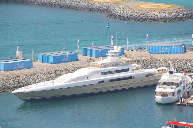 a large white boat in a harbor aboard SMERALDA Yacht for Sale