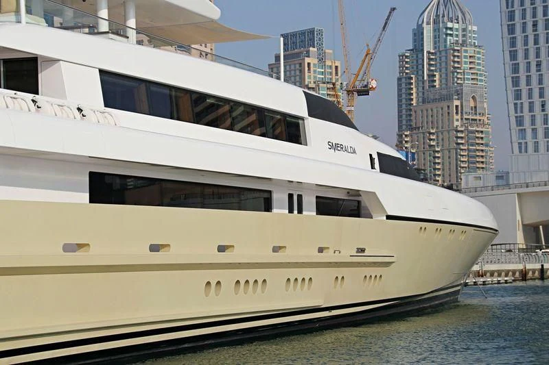 a white yacht in a harbor aboard SMERALDA Yacht for Sale