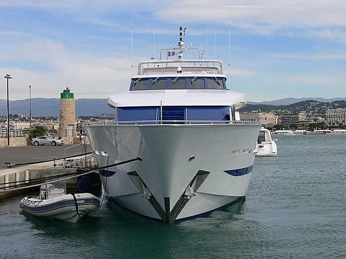 a large white boat docked at a pier aboard ESRA Yacht for Sale