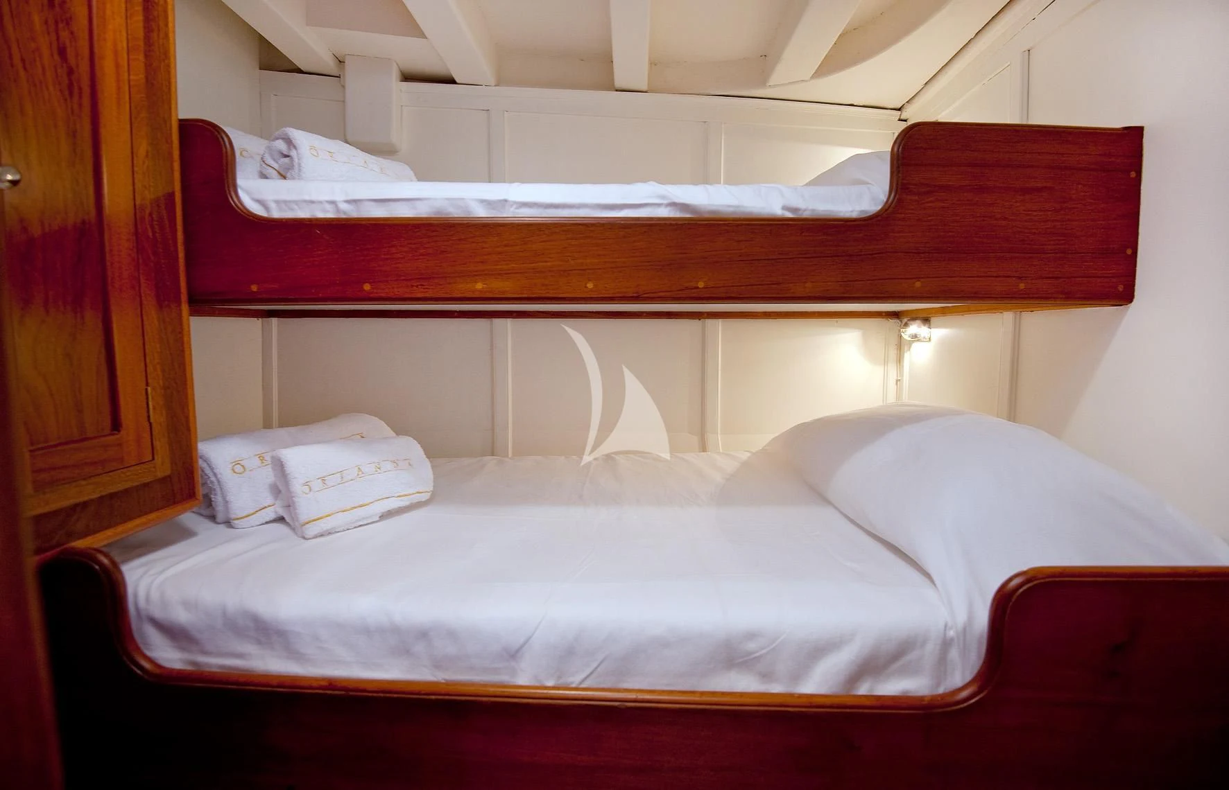 a bed with white sheets aboard ORIANDA Yacht for Charter