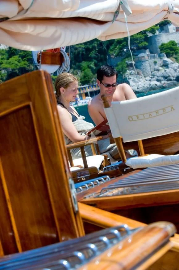 a group of people sitting at a table under a tent aboard ORIANDA Yacht for Charter
