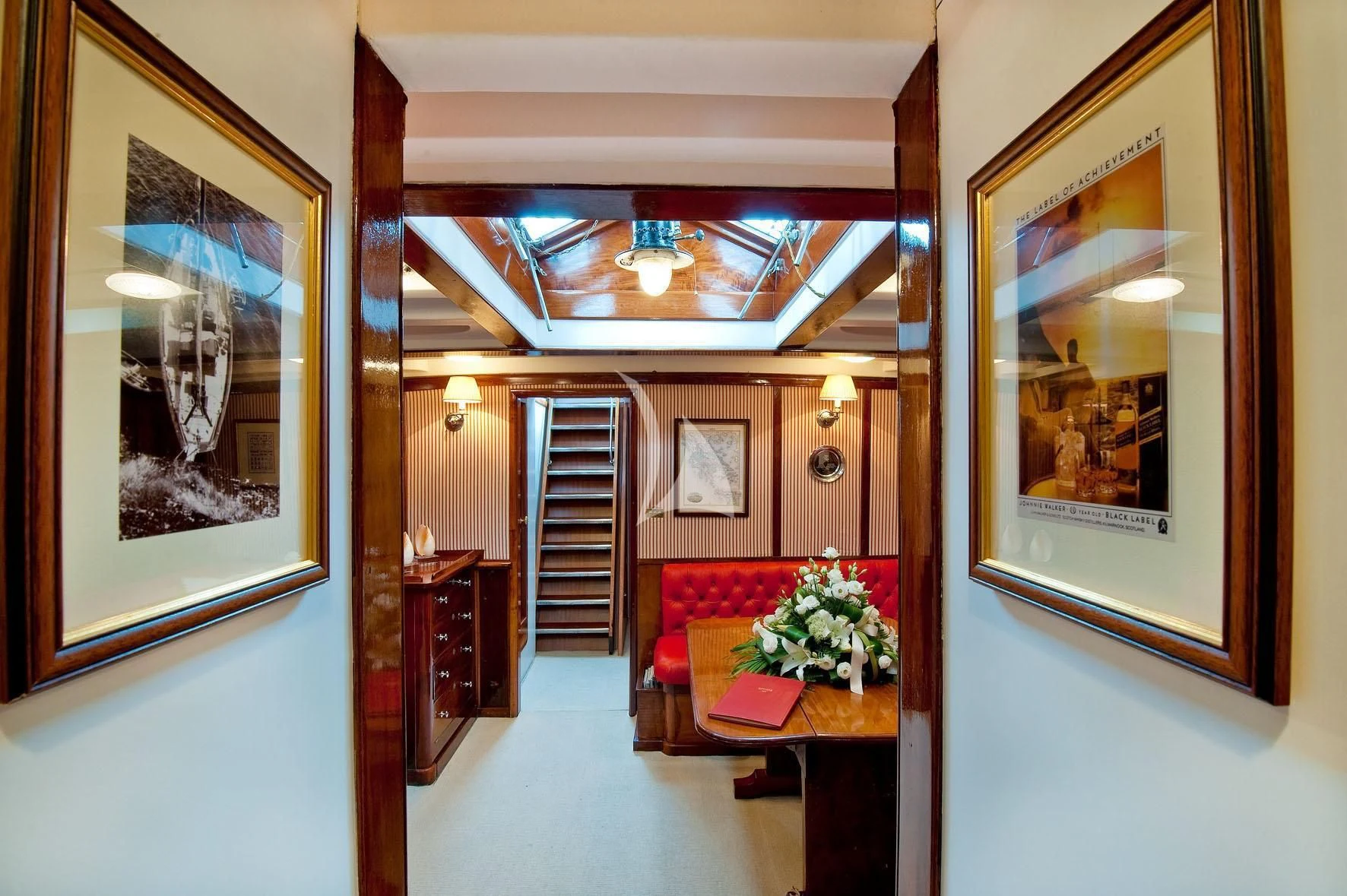 a living room with a red couch aboard ORIANDA Yacht for Charter