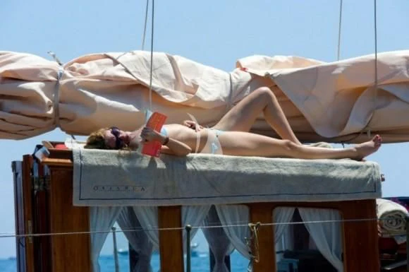 a person lying on a bed aboard ORIANDA Yacht for Charter
