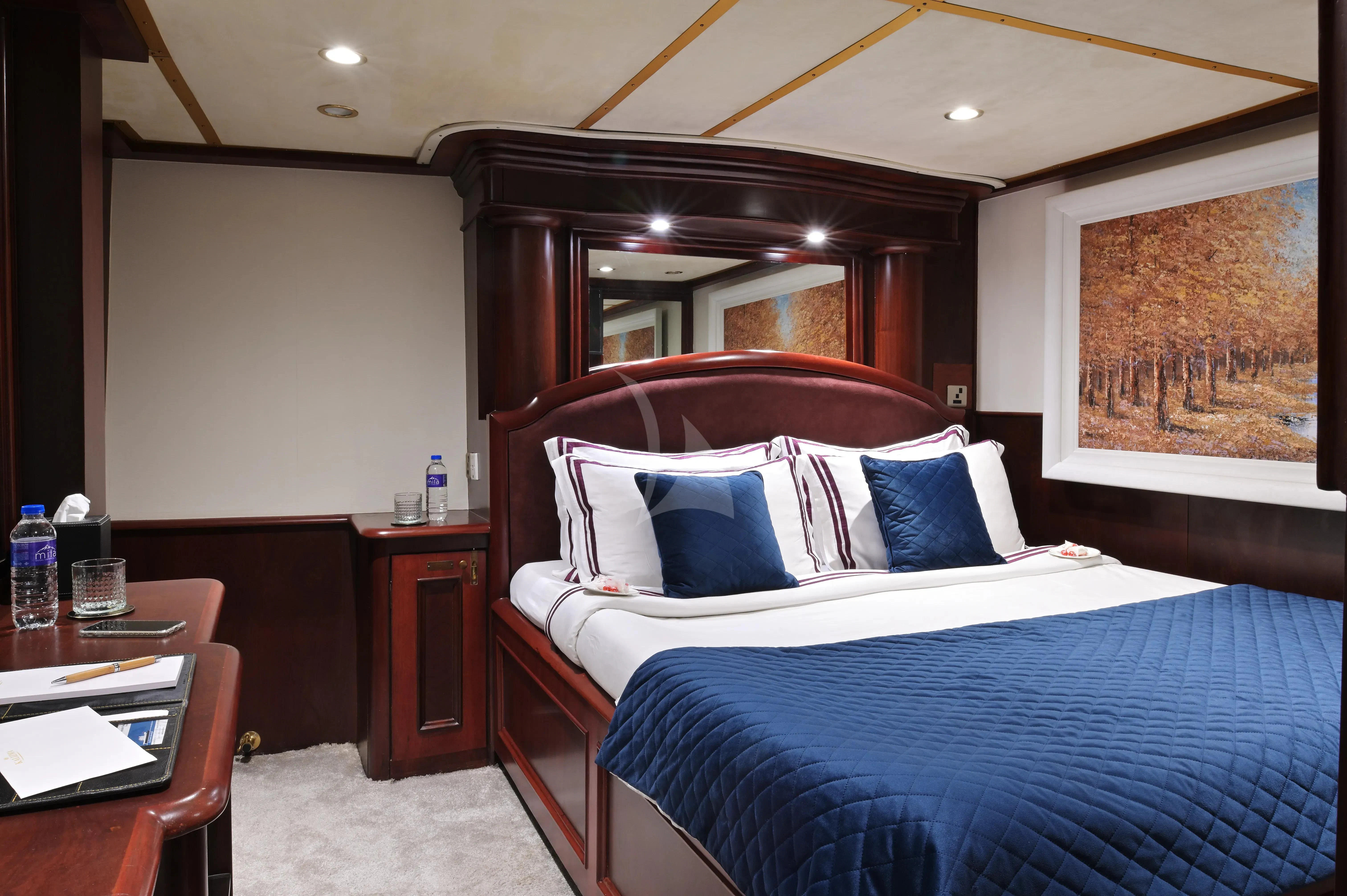 a bed with blue sheets aboard KALIZMA Yacht for Sale